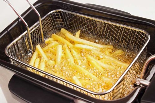 French fries in hot fat in a deep fryer